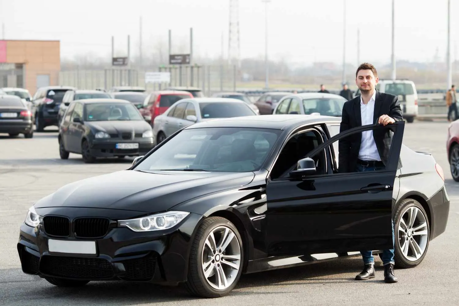 Driver standing beside a parked car